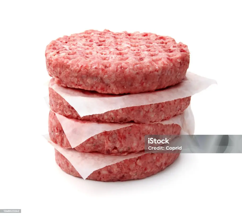 stack of fresh raw burger patty isolated on white